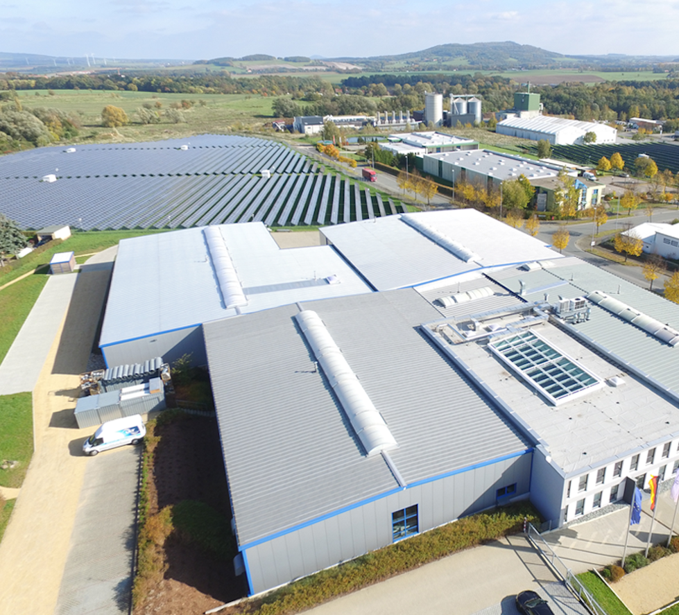 Im Vordergrund das ULT-Gebäude, dahinter PV-Anlagenfeld