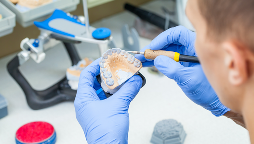 Medical technician works on a denture