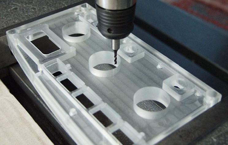 A milling cutter cuts a plastic part for automotive displays
