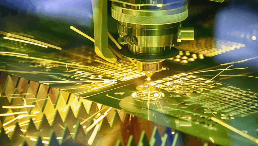 Laser cuts a printed circuit board for later use as electronics assembly