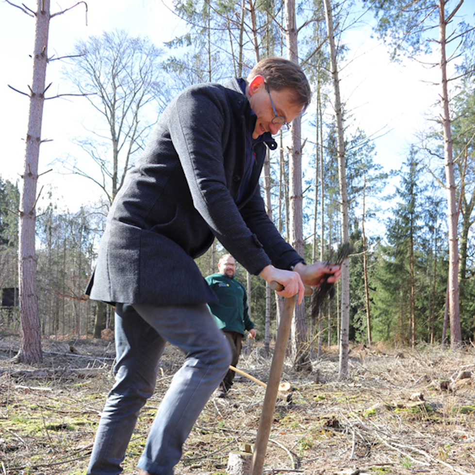 A man with spade is digging a hole